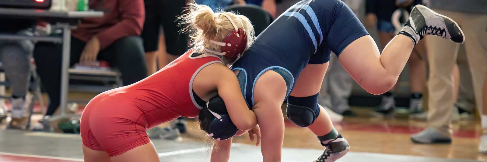 Female wrestlers on mat