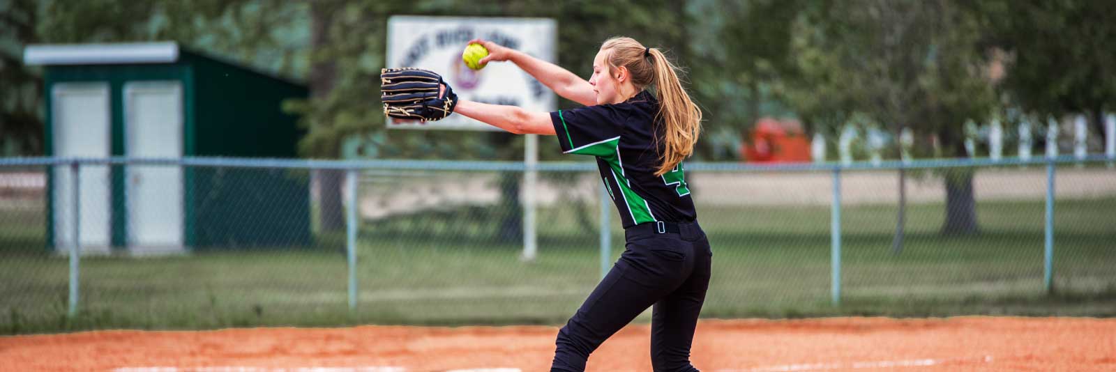 IMG softball player throwing pitch