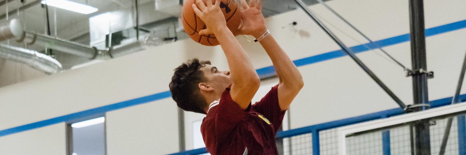 men's basketball athlete going for a lay up